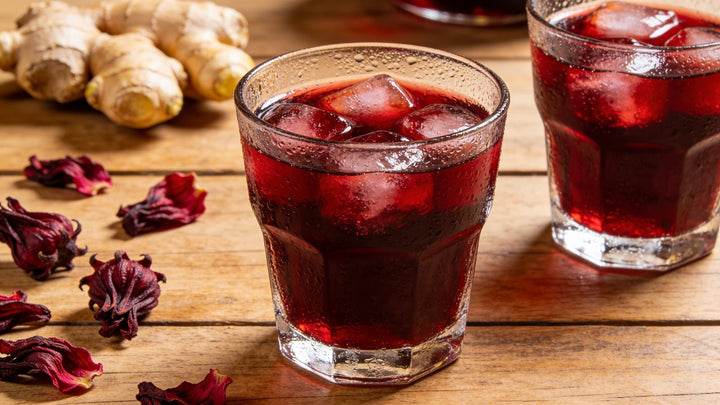 Two glasses of iced Jamaican sorrel drink with ginger and hibiscus