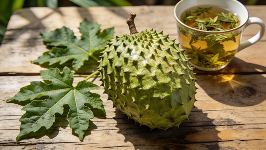 Whole soursop fruit with graviola leaves and a cup of herbal tea